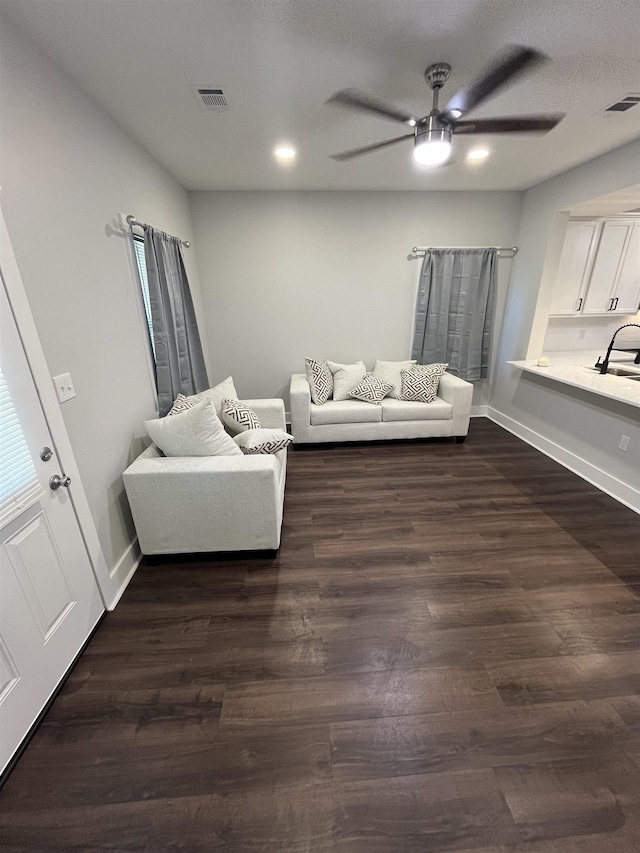 unfurnished living room featuring dark hardwood / wood-style flooring and ceiling fan