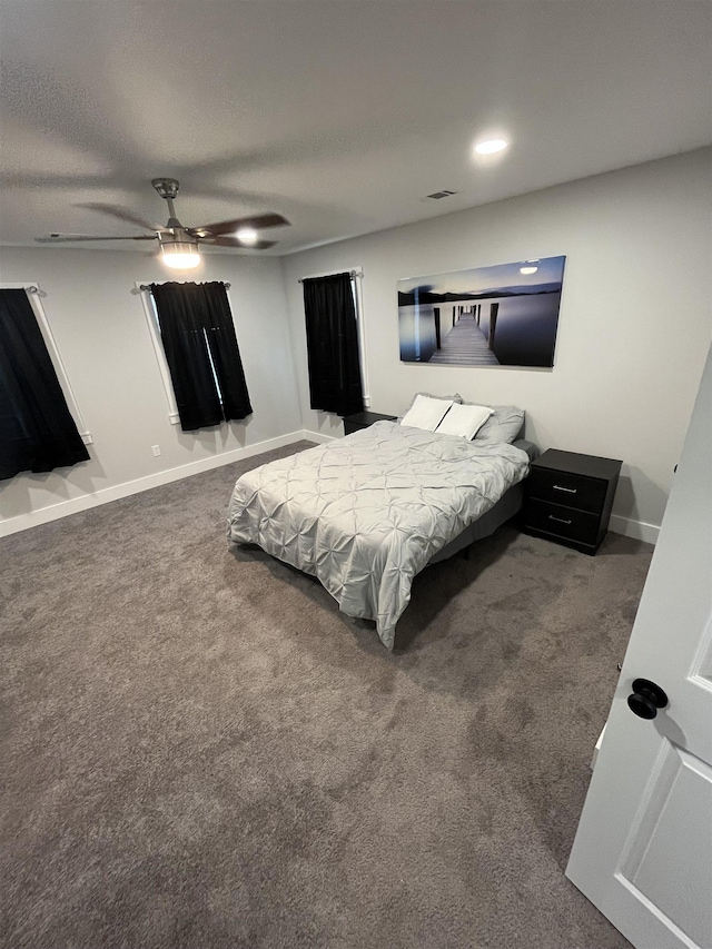 carpeted bedroom with a textured ceiling and ceiling fan