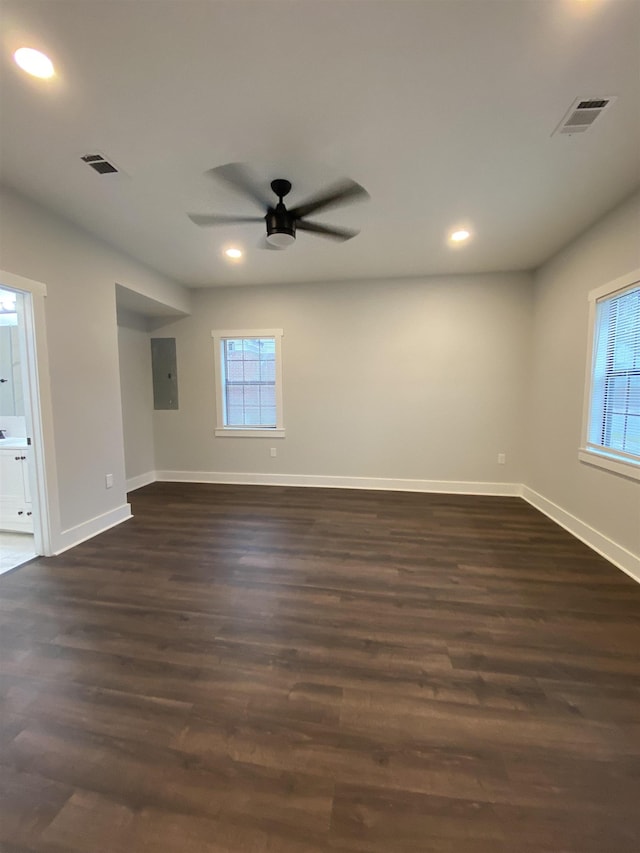 unfurnished room with dark wood-type flooring, ceiling fan, and electric panel