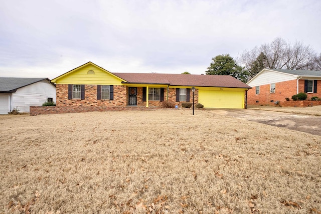 ranch-style home with brick siding, dirt driveway, and a garage