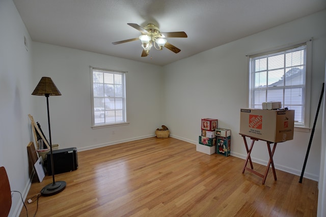 misc room with ceiling fan and light hardwood / wood-style flooring