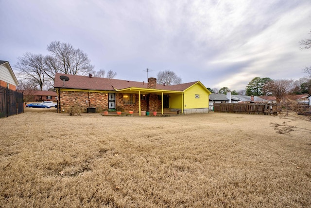 back of property with a chimney