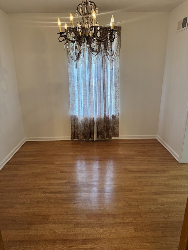 584 Shofner Ave, Memphis, TN 38109 - unfurnished dining area featuring wood finished floors and a chandelier
