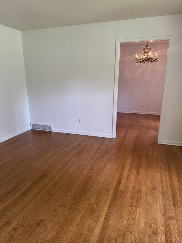 584 Shofner Ave, Memphis, TN 38109 - unfurnished room with a chandelier and dark wood-style floors