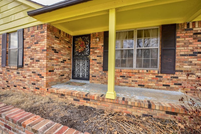 view of exterior entry featuring covered porch