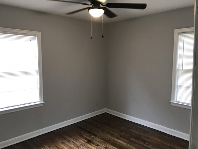 spare room featuring plenty of natural light, dark hardwood / wood-style floors, and ceiling fan