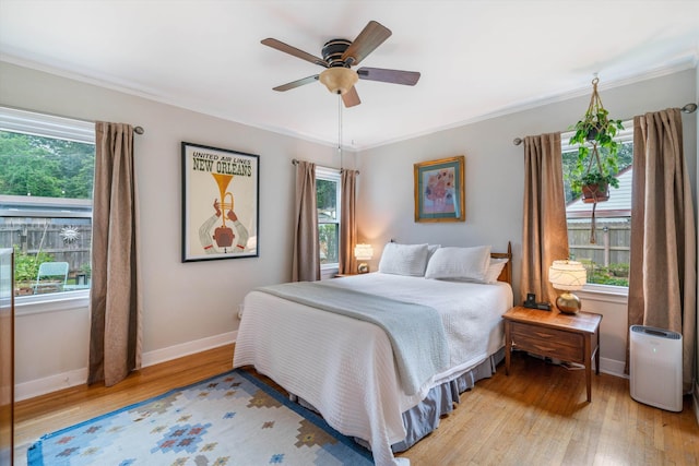 bedroom featuring crown molding, ceiling fan, and light wood-type flooring