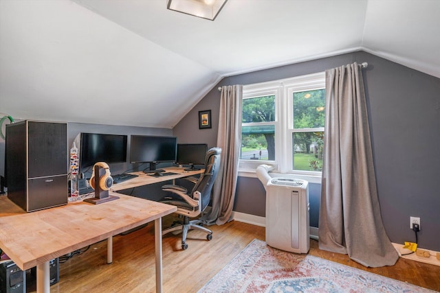 office space featuring light hardwood / wood-style floors and vaulted ceiling