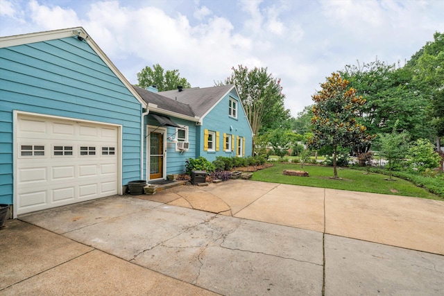 view of front facade with a garage, a front yard, and cooling unit