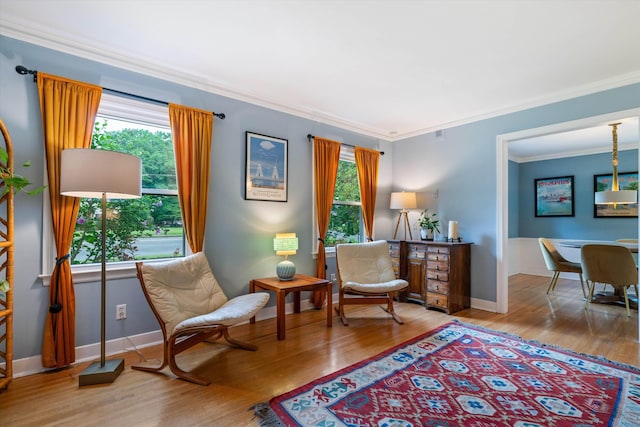 sitting room featuring hardwood / wood-style floors and crown molding