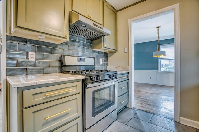 kitchen with light tile patterned floors, crown molding, stainless steel gas range oven, light stone countertops, and decorative backsplash