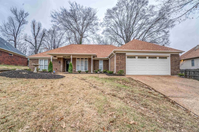 ranch-style house featuring a garage and a front lawn