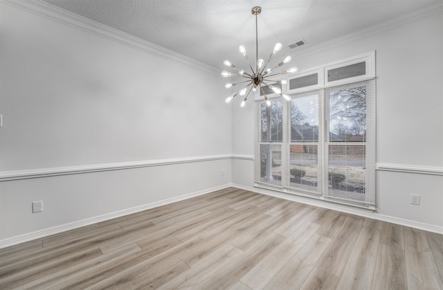 unfurnished dining area with an inviting chandelier, light hardwood / wood-style flooring, ornamental molding, and a textured ceiling