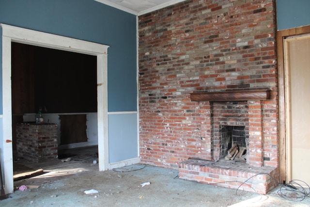 unfurnished living room with crown molding and a brick fireplace