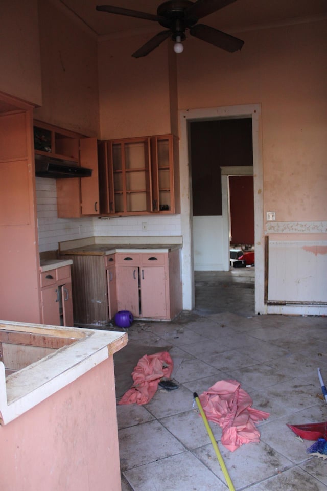 kitchen with ceiling fan and decorative backsplash