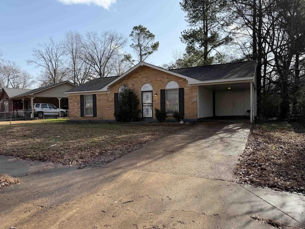 ranch-style home featuring a carport