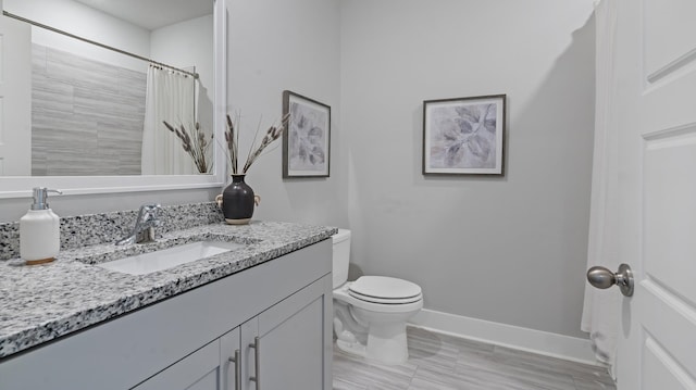 bathroom featuring walk in shower, vanity, and toilet