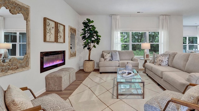 living room with plenty of natural light and light wood-type flooring