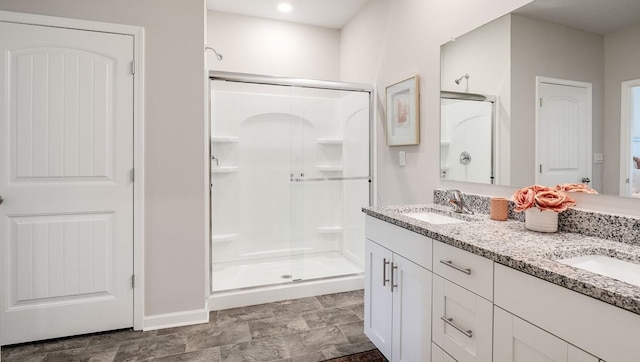 bathroom with an enclosed shower and vanity