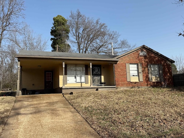 ranch-style home with a carport and covered porch