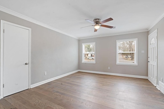 spare room with ornamental molding, ceiling fan, and light hardwood / wood-style flooring