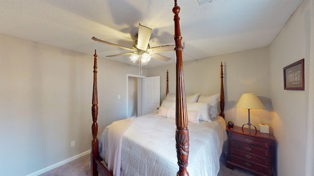 carpeted bedroom featuring a textured ceiling and ceiling fan