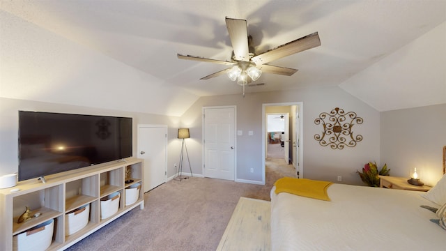 carpeted bedroom with vaulted ceiling and ceiling fan