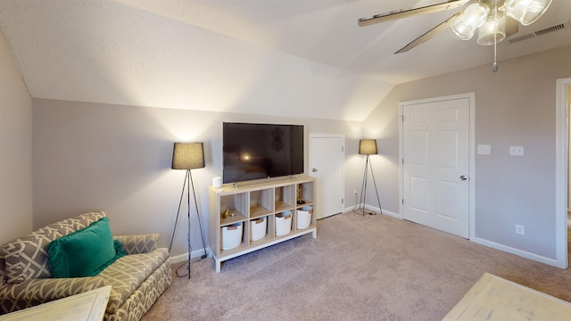 interior space featuring vaulted ceiling, light colored carpet, and ceiling fan