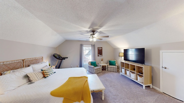 bedroom with ceiling fan, lofted ceiling, carpet flooring, and a textured ceiling