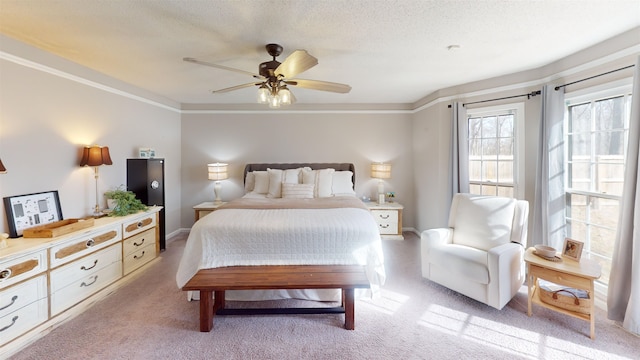 bedroom featuring light carpet, crown molding, and a textured ceiling