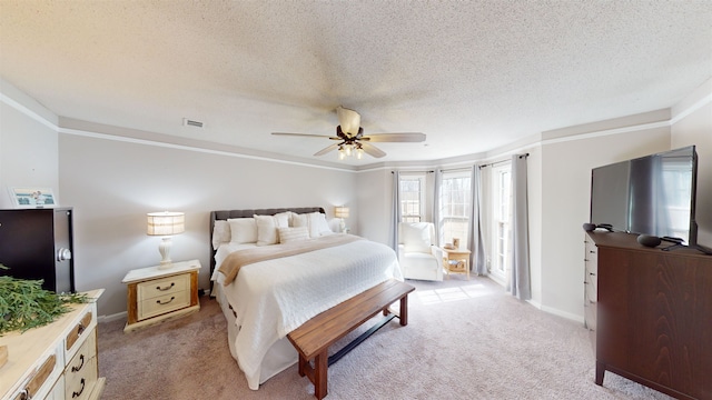 carpeted bedroom with ceiling fan and a textured ceiling