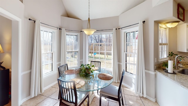 dining space with sink and vaulted ceiling