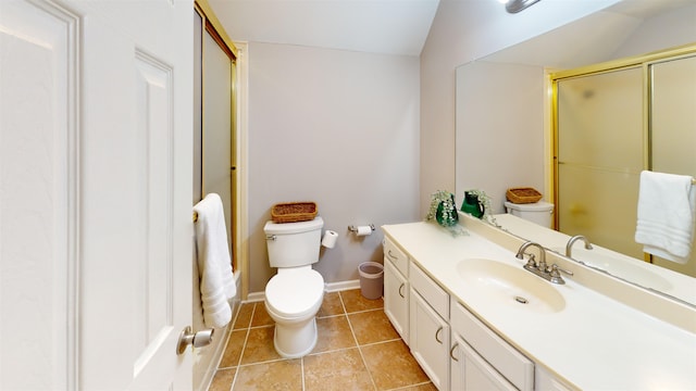 bathroom with an enclosed shower, vanity, tile patterned floors, and toilet