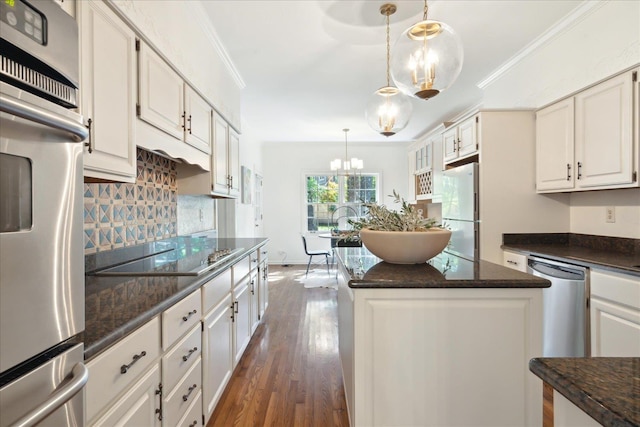 kitchen with white cabinetry, pendant lighting, a center island, and appliances with stainless steel finishes