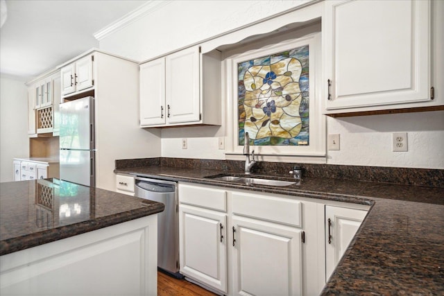 kitchen with white cabinetry, sink, white refrigerator, stainless steel dishwasher, and crown molding