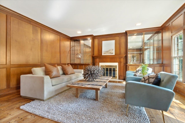 living room featuring crown molding and light wood-type flooring