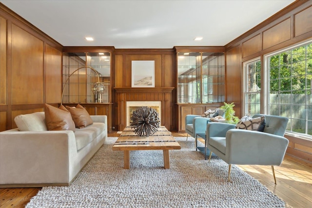 living room featuring ornamental molding and light wood-type flooring