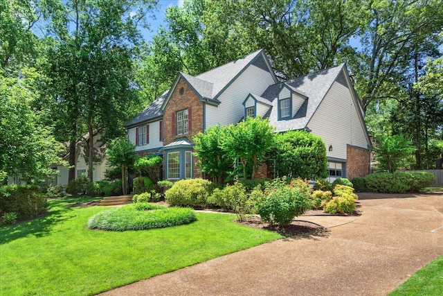 view of front of property with a garage and a front lawn