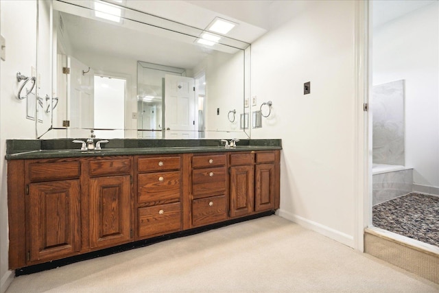 bathroom featuring walk in shower and vanity