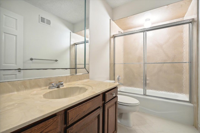 full bathroom featuring vanity, a textured ceiling, toilet, and combined bath / shower with glass door