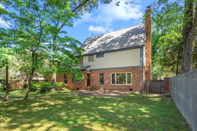 back of property featuring a patio area and a lawn