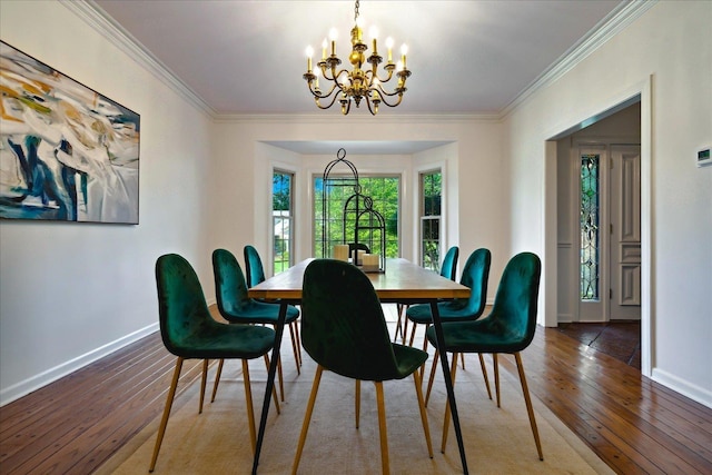 dining room with crown molding, hardwood / wood-style flooring, and a chandelier