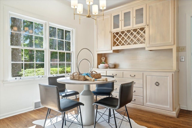 dining space featuring a notable chandelier and light wood-type flooring