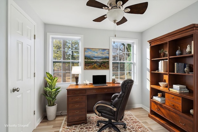 office space featuring ceiling fan, a healthy amount of sunlight, and light wood-type flooring