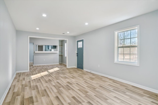 unfurnished living room with light wood-type flooring