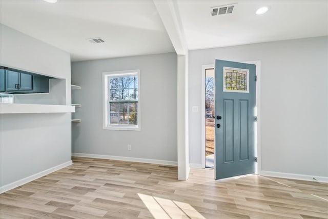 foyer featuring beam ceiling and light hardwood / wood-style floors