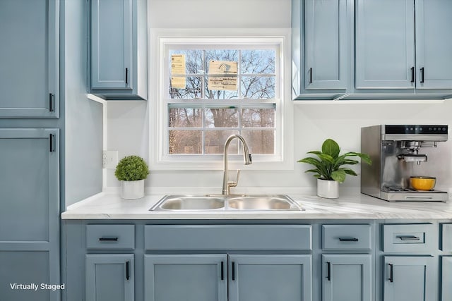 bar featuring light stone countertops and sink