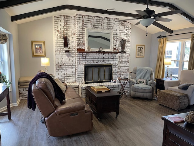 living room with ceiling fan, a fireplace, lofted ceiling with beams, and wood-type flooring