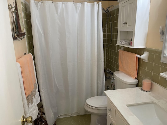 bathroom with walk in shower, tile patterned floors, toilet, tile walls, and vanity