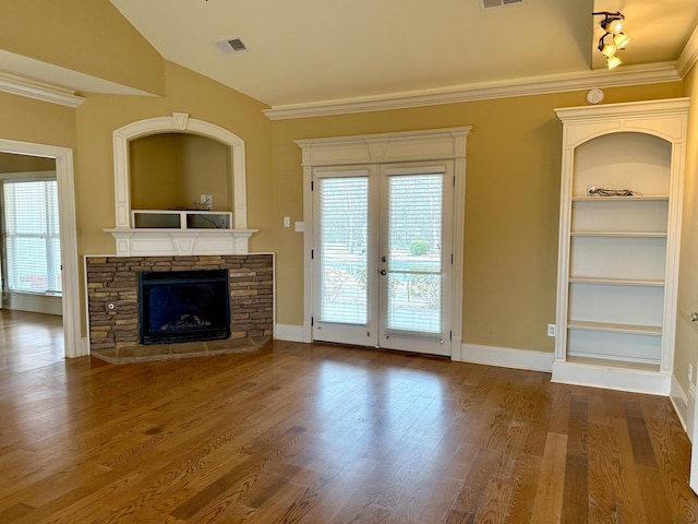 unfurnished living room featuring hardwood / wood-style floors, a fireplace, and ornamental molding